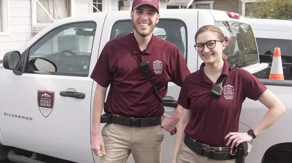 Security Services personnel in front of security vehicle