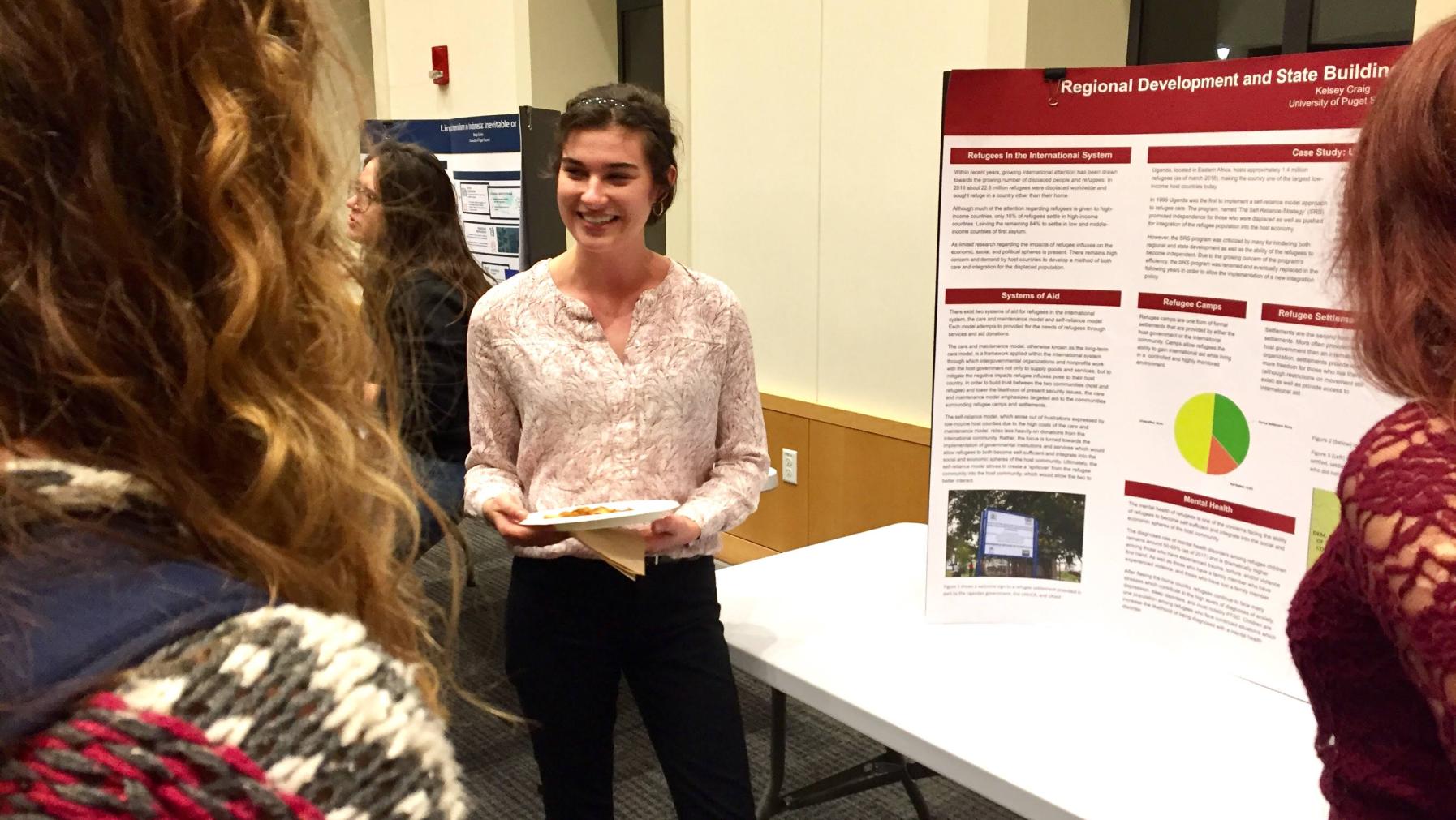GDS senior presenting research at year-end symposium.
