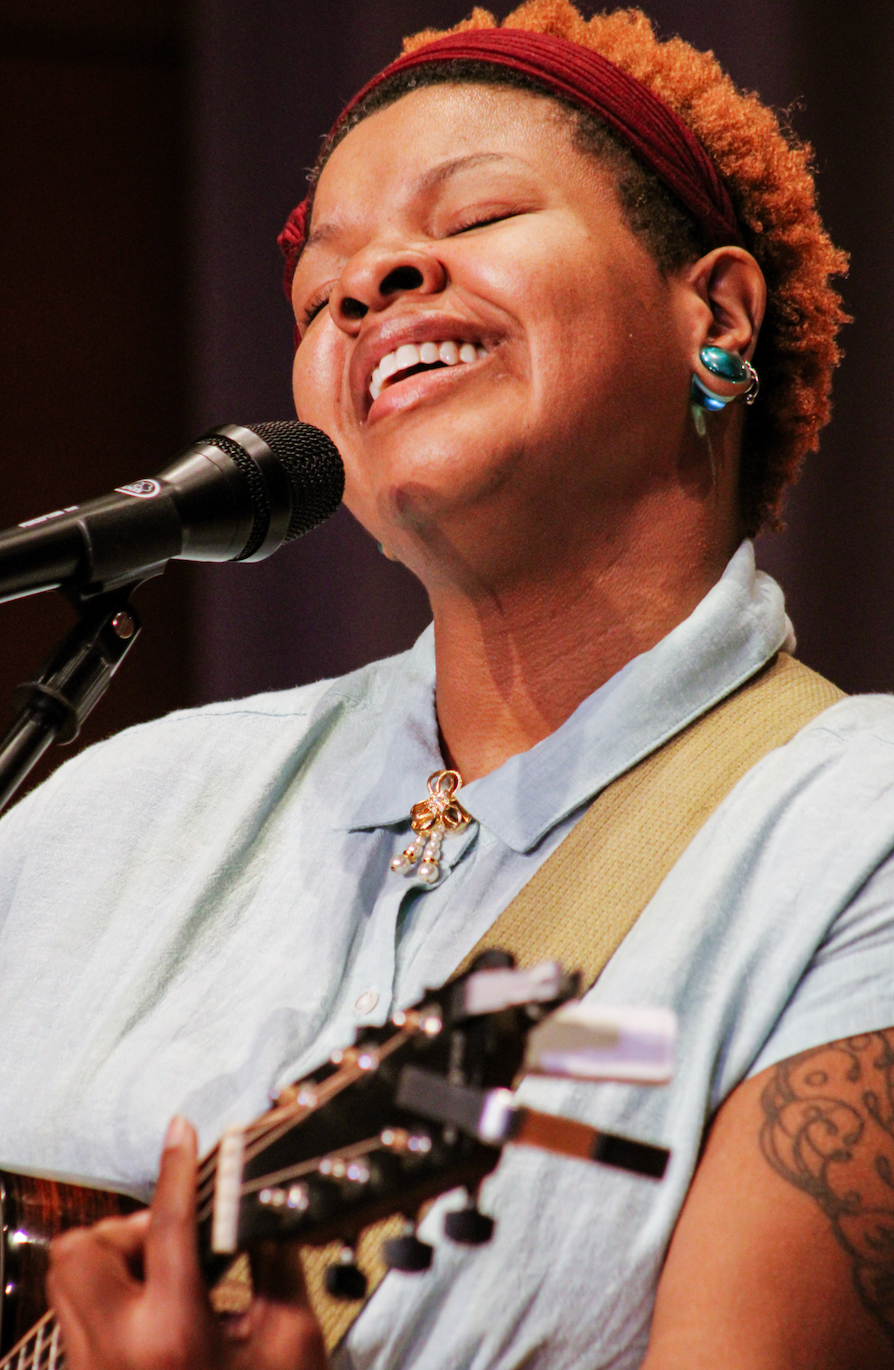 A singer performing with guitar