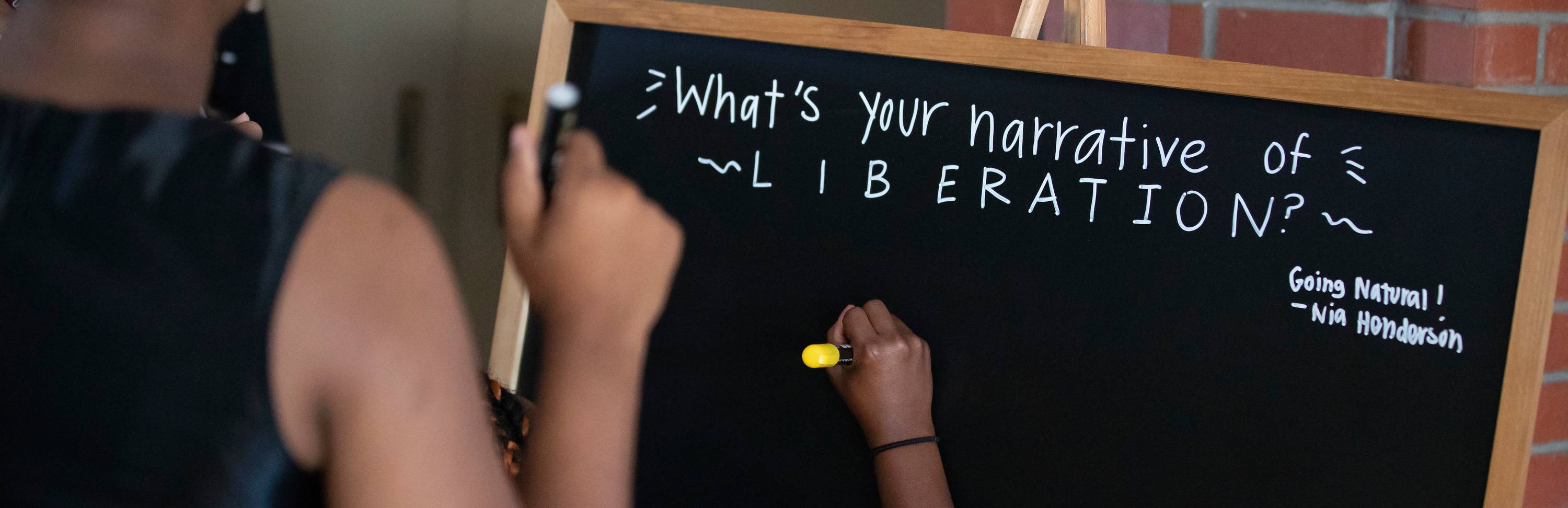 Students respond to a question board at a BSU One More Scholarship fundraising dinner.