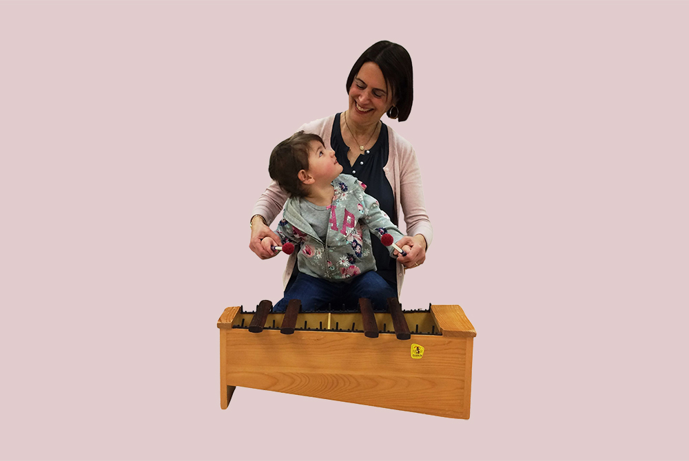 Adult with child and music instrument