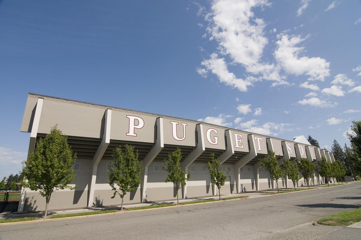 Rear view of football bleachers with the words Puget Sound displayed on the walls. 