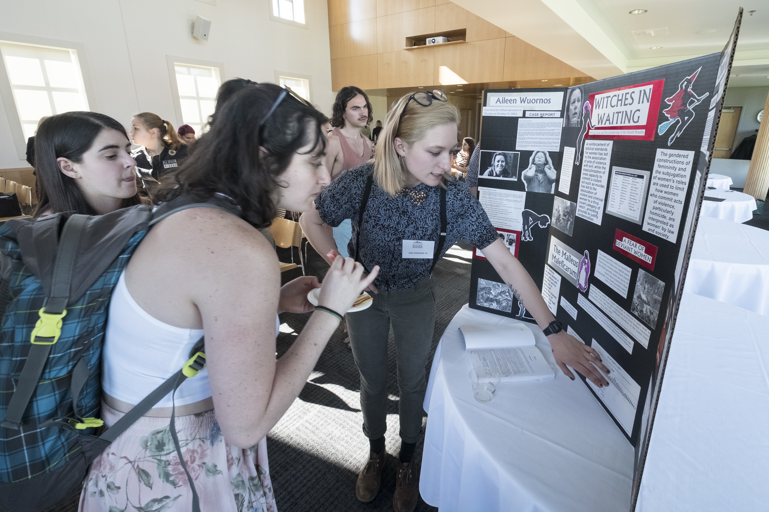 Students present and observe at a poster session.