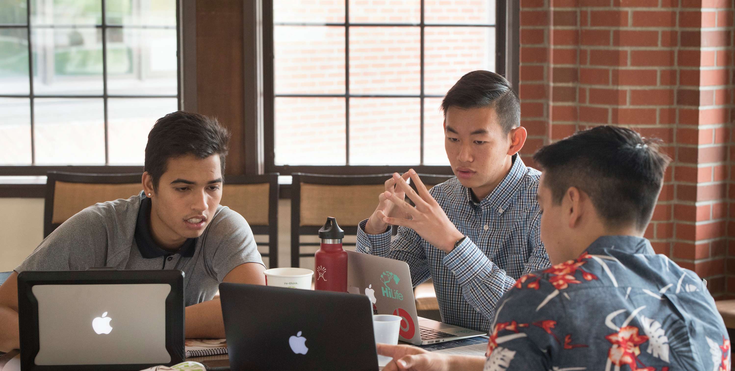 Three students work together on a project.