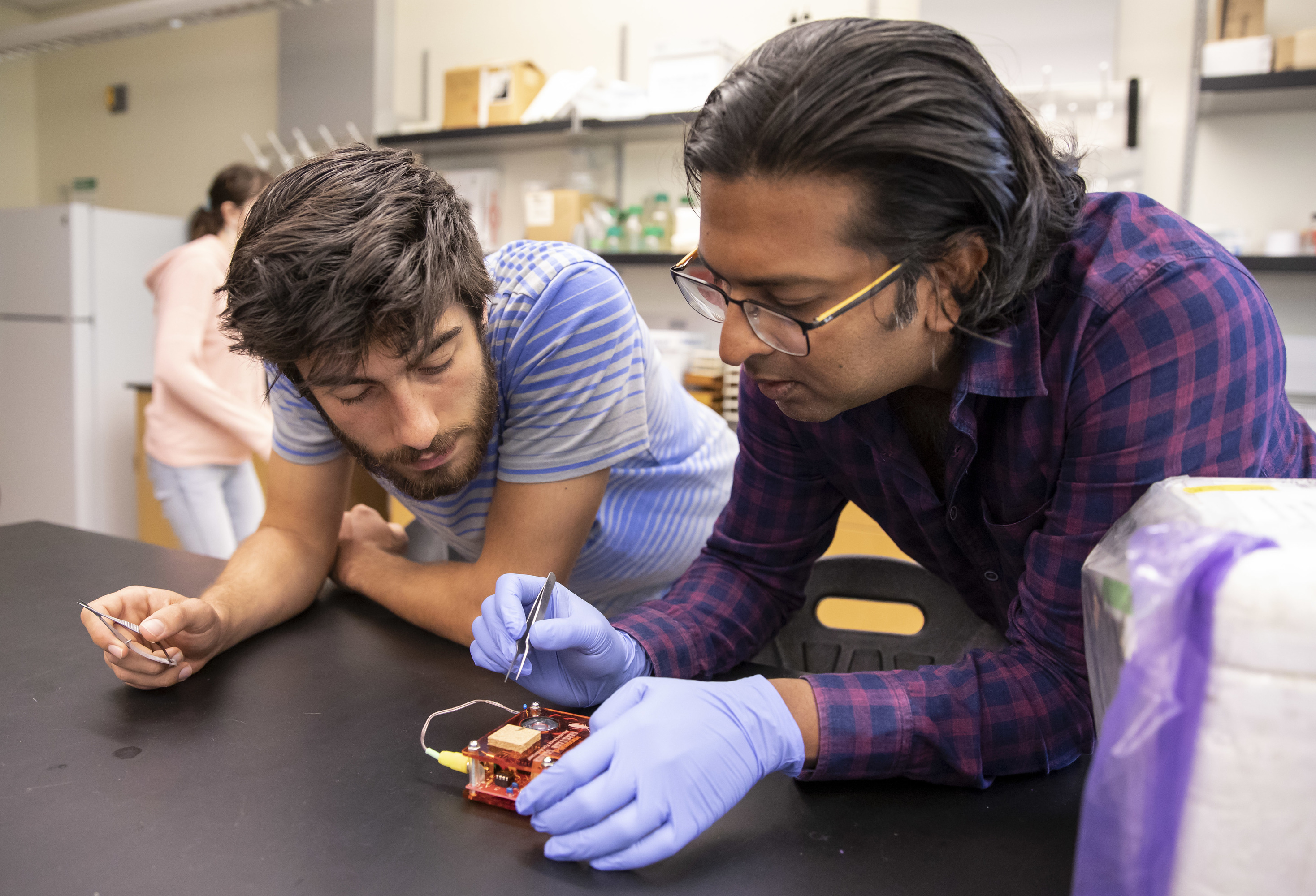 Professor Ramakrishnan works with a student.