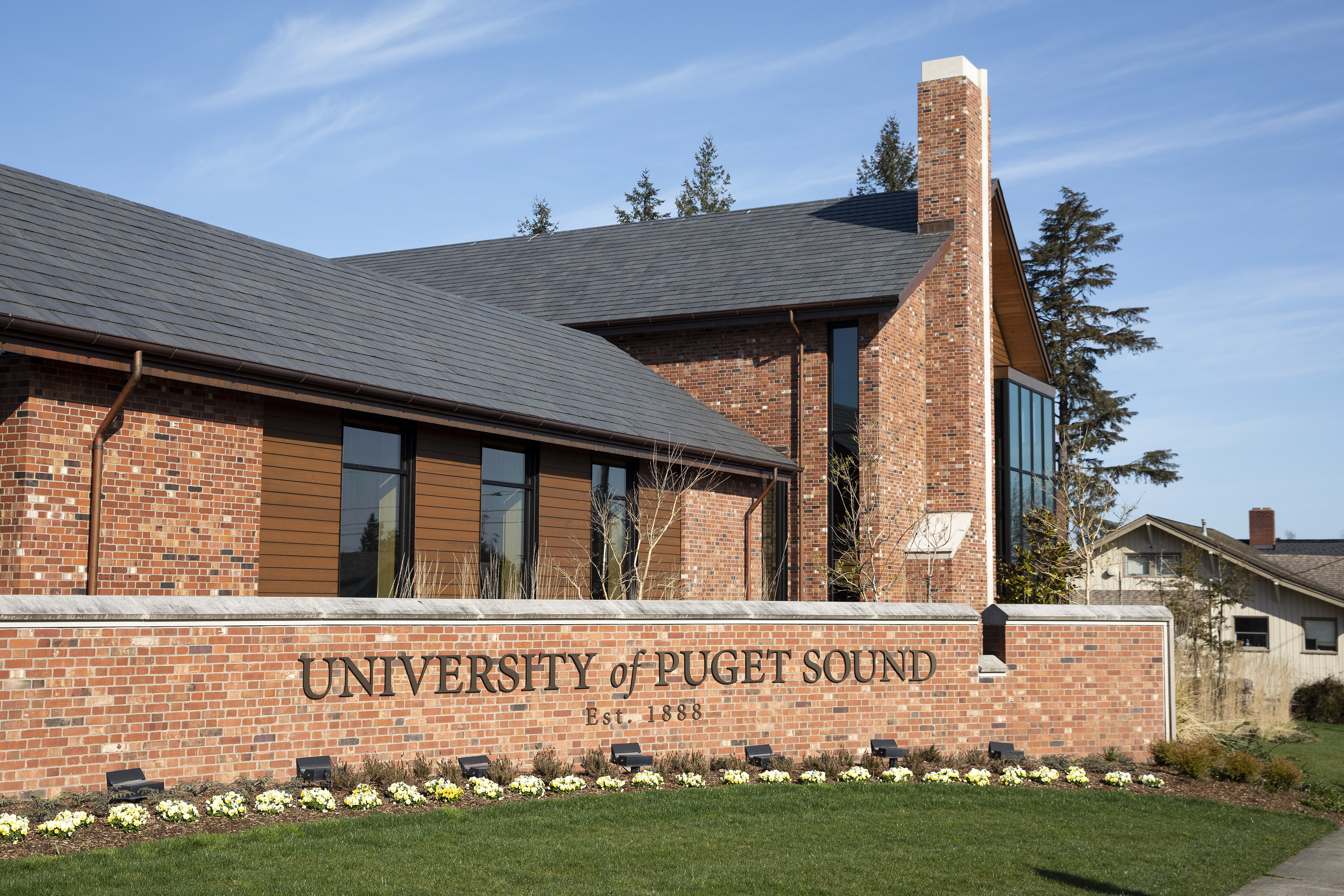 Red brick building with brick sign saying "University of Puget Sound"