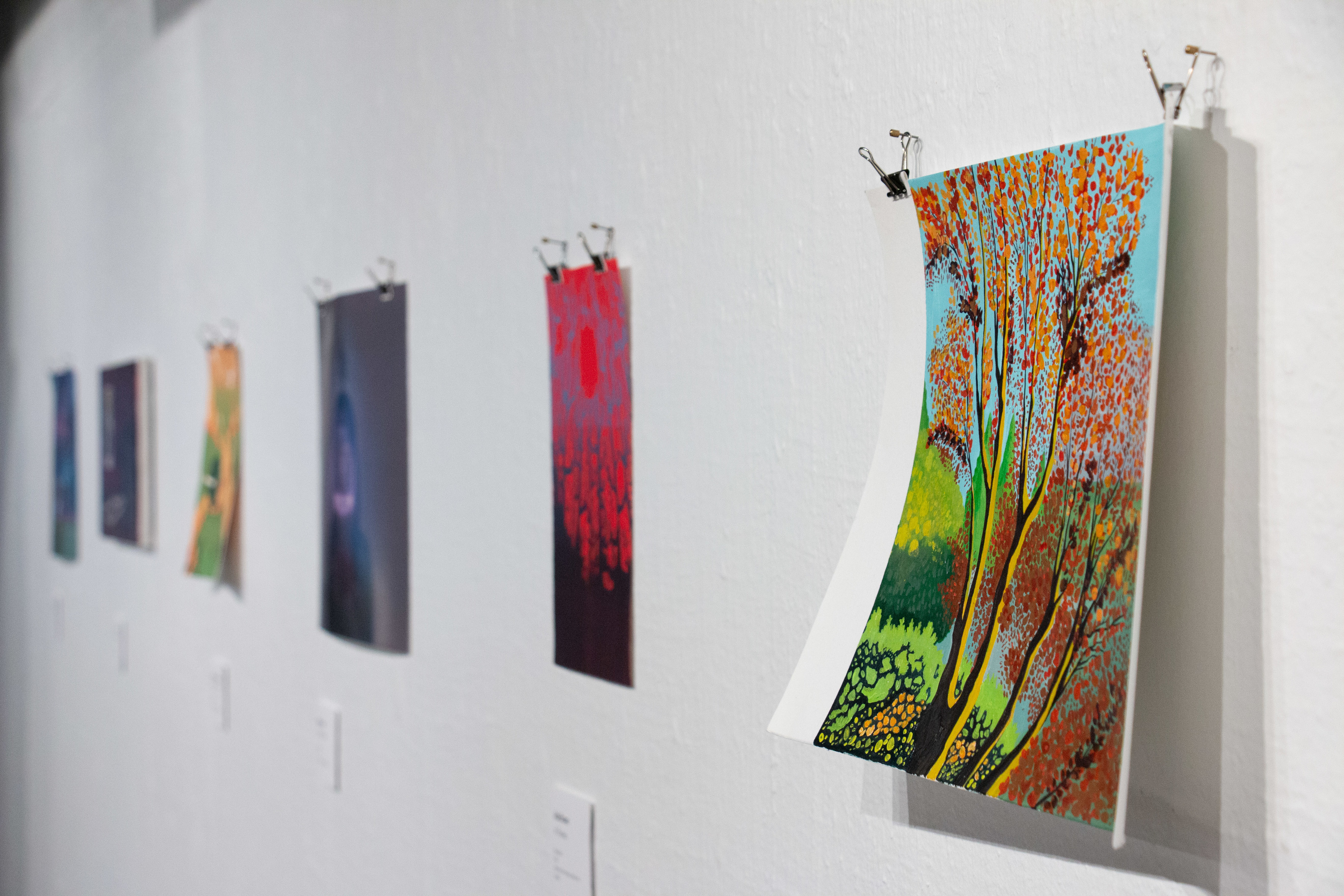 Student artworks hanging on a gallery wall