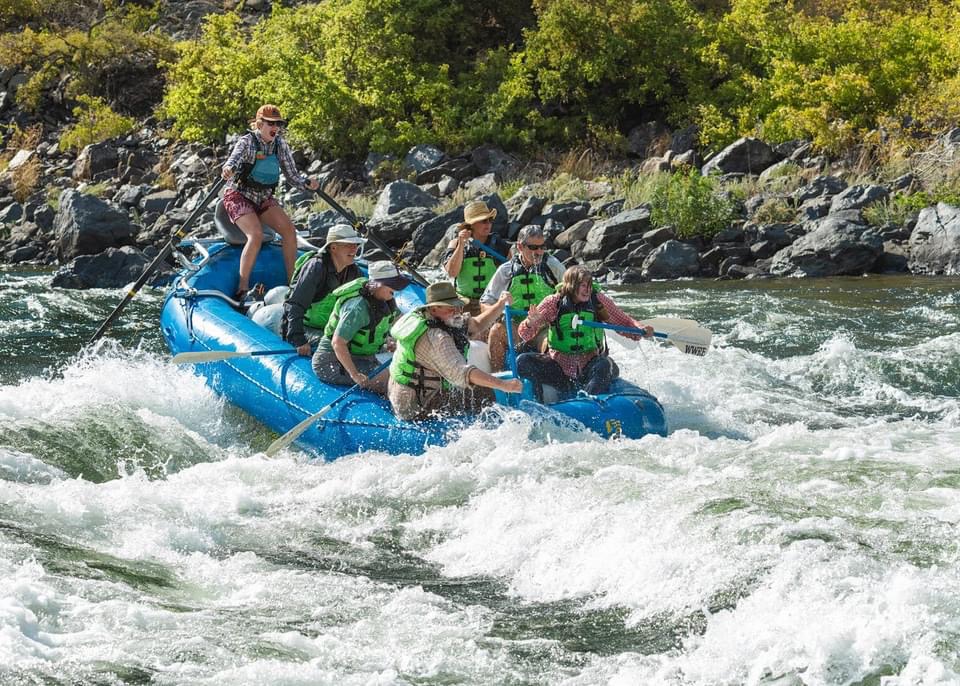 People wearing life vests on a Hell's Canyon river rafting trip