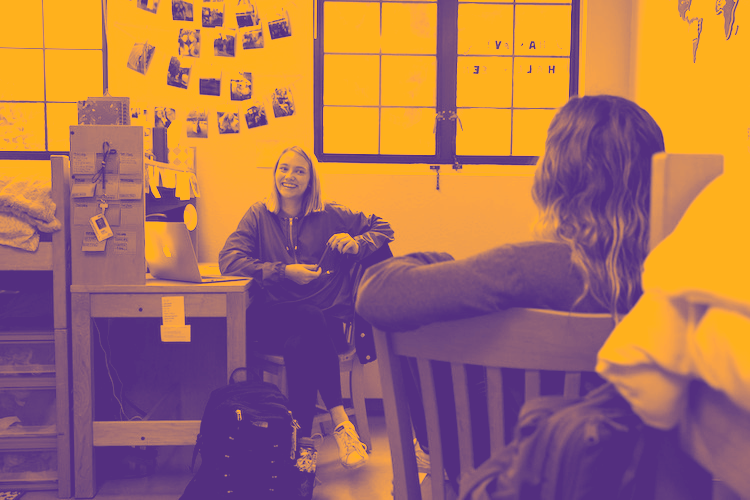 Students in residence hall room (yellowish filter on picture)