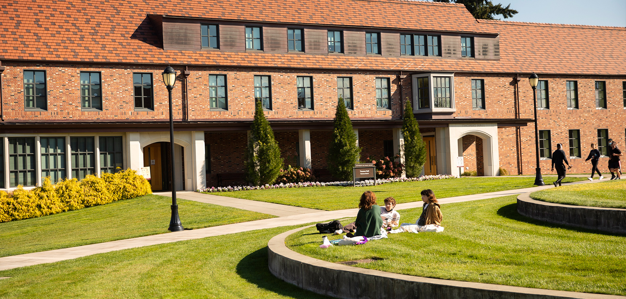 Students study on the Event Lawn near Thomas Hall. 