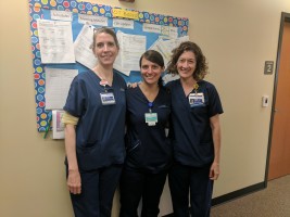 Three students wearing medical scrubs