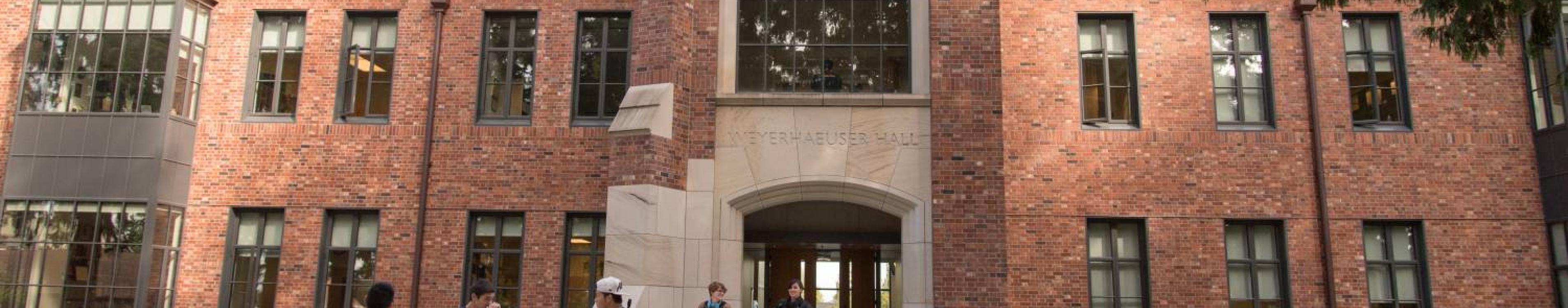 People outside the front of the Weyerhaeuser Hall building on campus