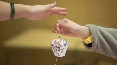 Hands holding an Asian decoration