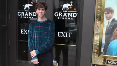 Student standing in front of a building