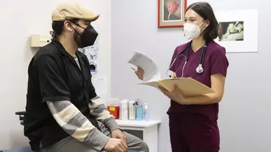 Capriana Jiang ’22 (right) with a visitor of Tacoma's Neighborhood Clinic