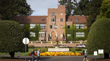 Jones Hall sits behind a flower garden on campus. 