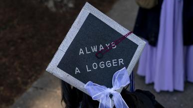 A graduation cap with the words "ALWAYS A LOGGER" spelled out on top. 