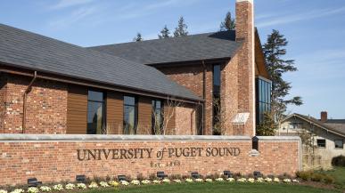 Red brick building with sign that states "University of Puget Sound"