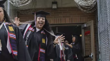 A smiling grad at the FEPPS Commencement ceremony in June 2024.