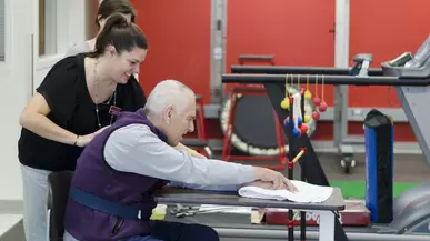 A student works with a clinic patient.