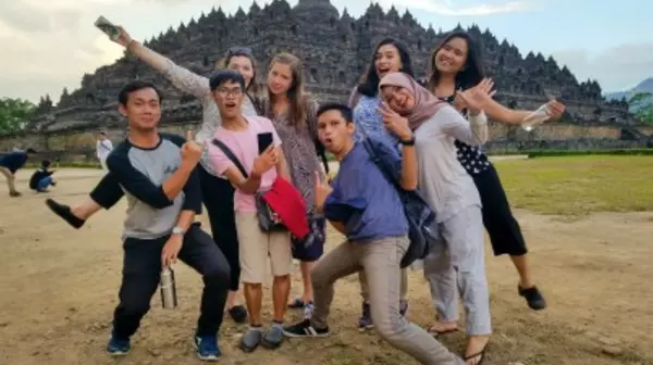 A group of students posing in front of a temple ruin