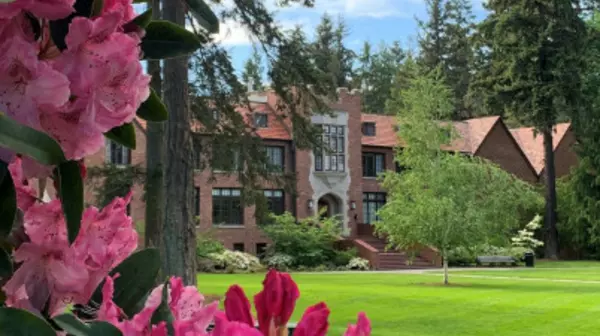 Campus building with flowers in foreground