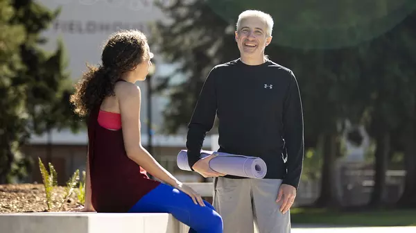 Faculty colleagues chat on Commencement Walk