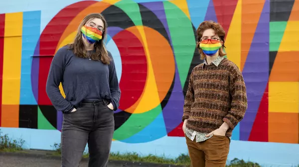 Anna Mondschean ’21, left, and Dana Levy ’21 stand in front of a Tacoma mural reading LOVE