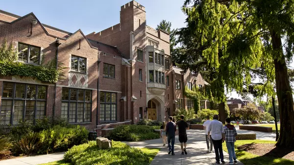 Picture of Collins Memorial Library with several students talking towards it.