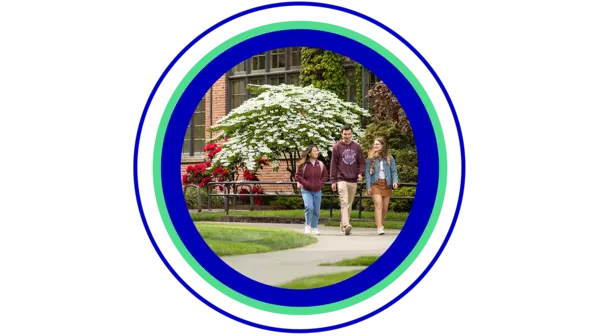 Three students walking and talking together in front of campus building