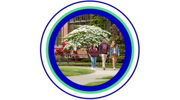 Three students walking and talking together in front of campus building