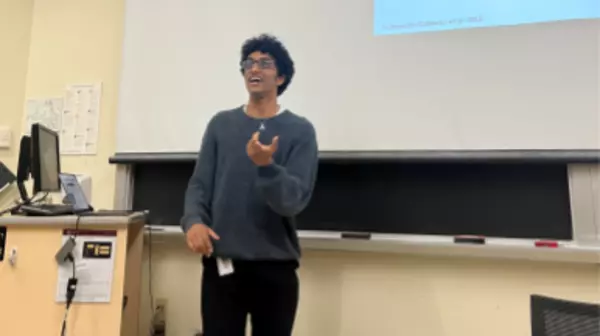 Ishaan Gollamudi presenting a talk in a lecture hall