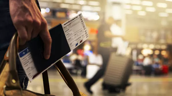 holding passport in an airport