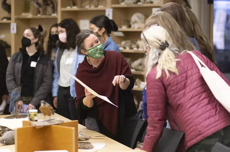 People discuss specimens on display at Slater Museum