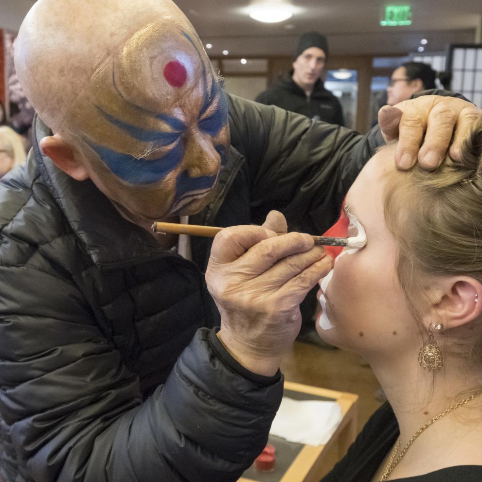 A student gets their face painted during a Lunar New Year celebration.