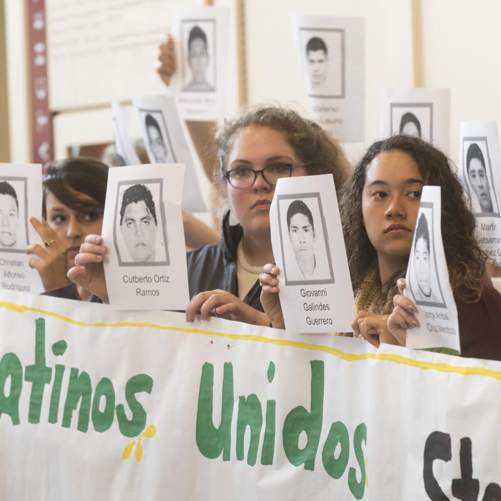 Students in Latinos Unidos stage a silent protest in the student center.