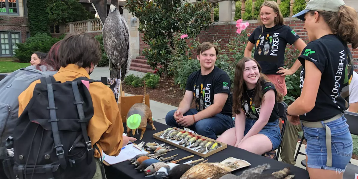 Student docents staff the museum table at LogJam.