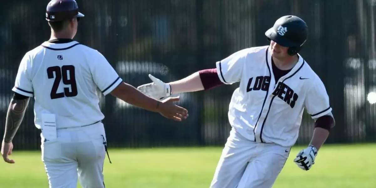 Logger baseball players tap hands as one rounds the bases.