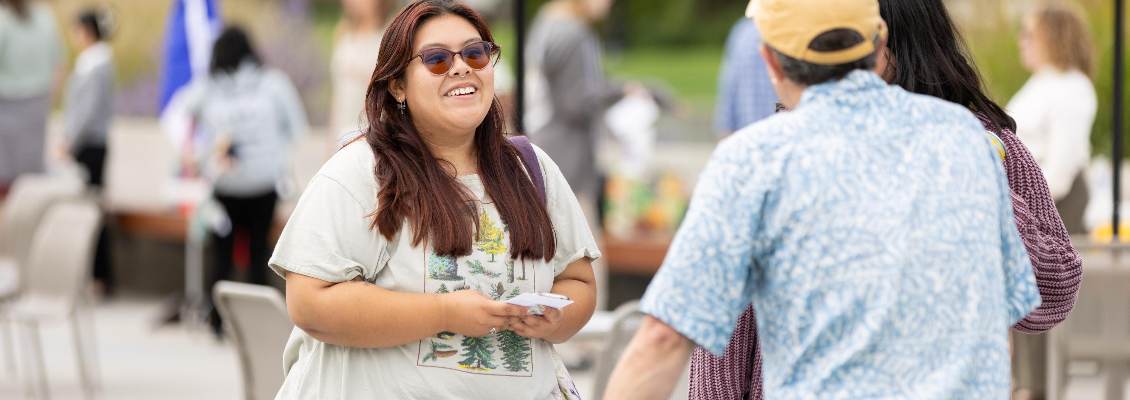 Students chat on the plaza outside Wheelock Student Center.