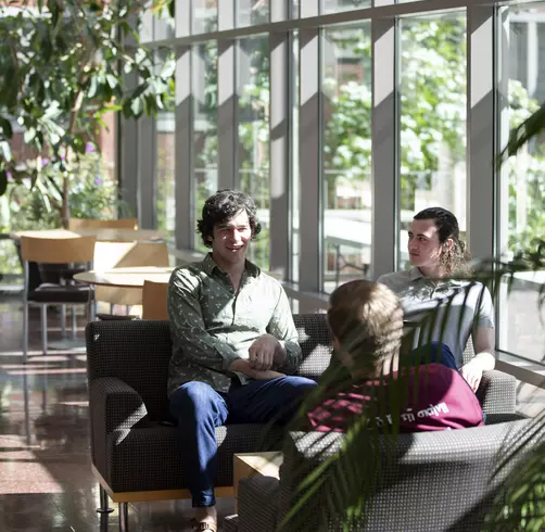 Student talking and studying in Harned Hall