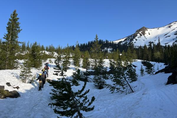 PacTrail students climb a snowy mountainside.