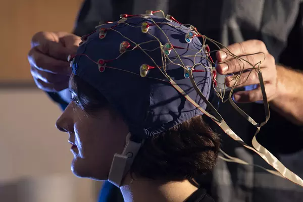 Student having sensors attached to their head via a special cap