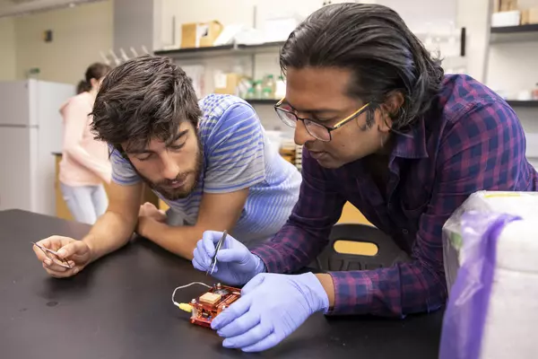 Professor Ramakrishnan works with a student.