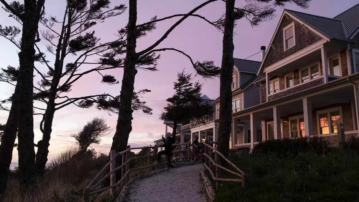 Path leading up to a house in a purple sunset