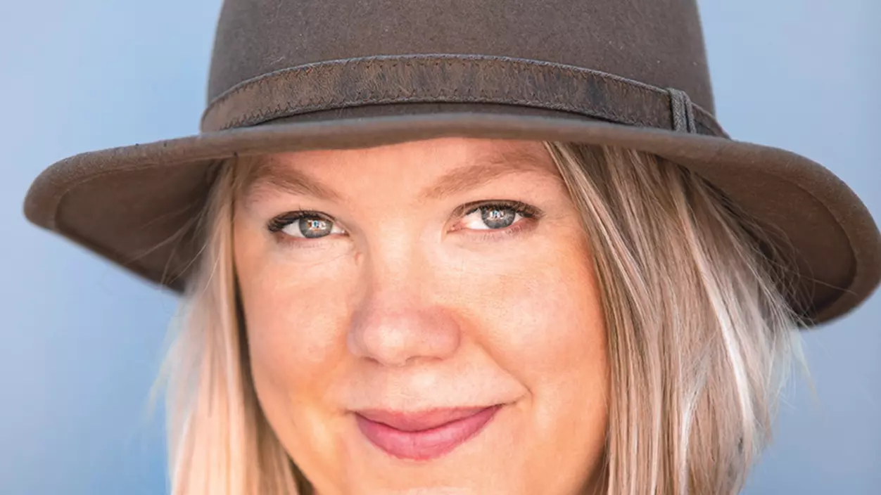 Anna Bugge ’03 smiling and wearing a gray hat