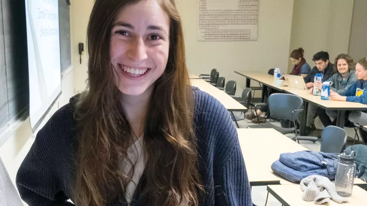 A person smiling in a classroom