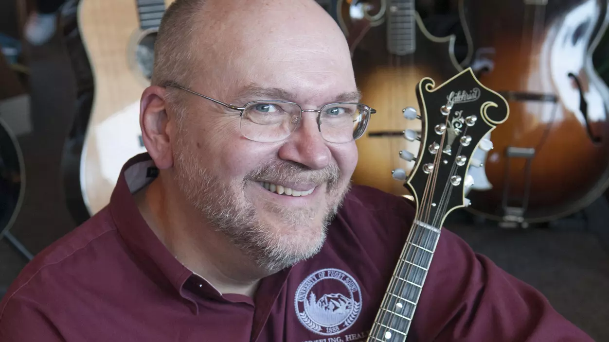 Person posing with a stringed instrument