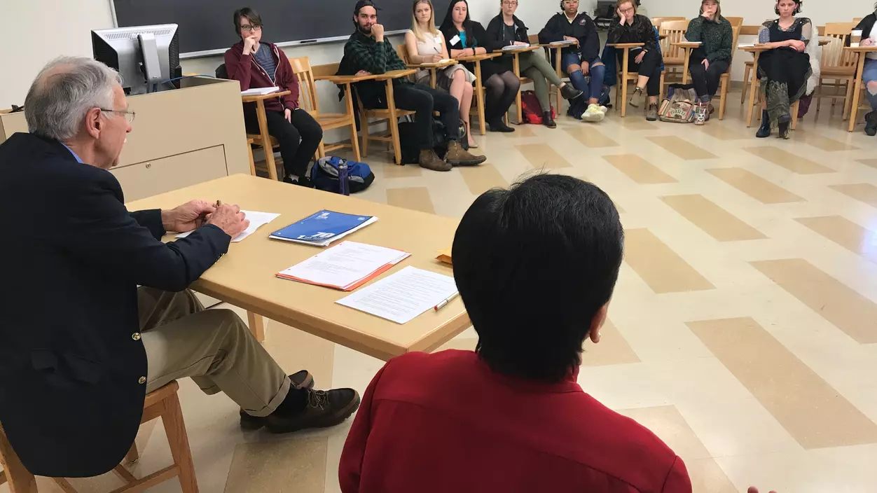 A group of people having a discussion in a classroom