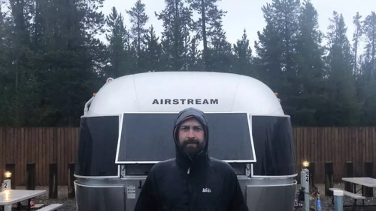 A person standing in front of a trailer