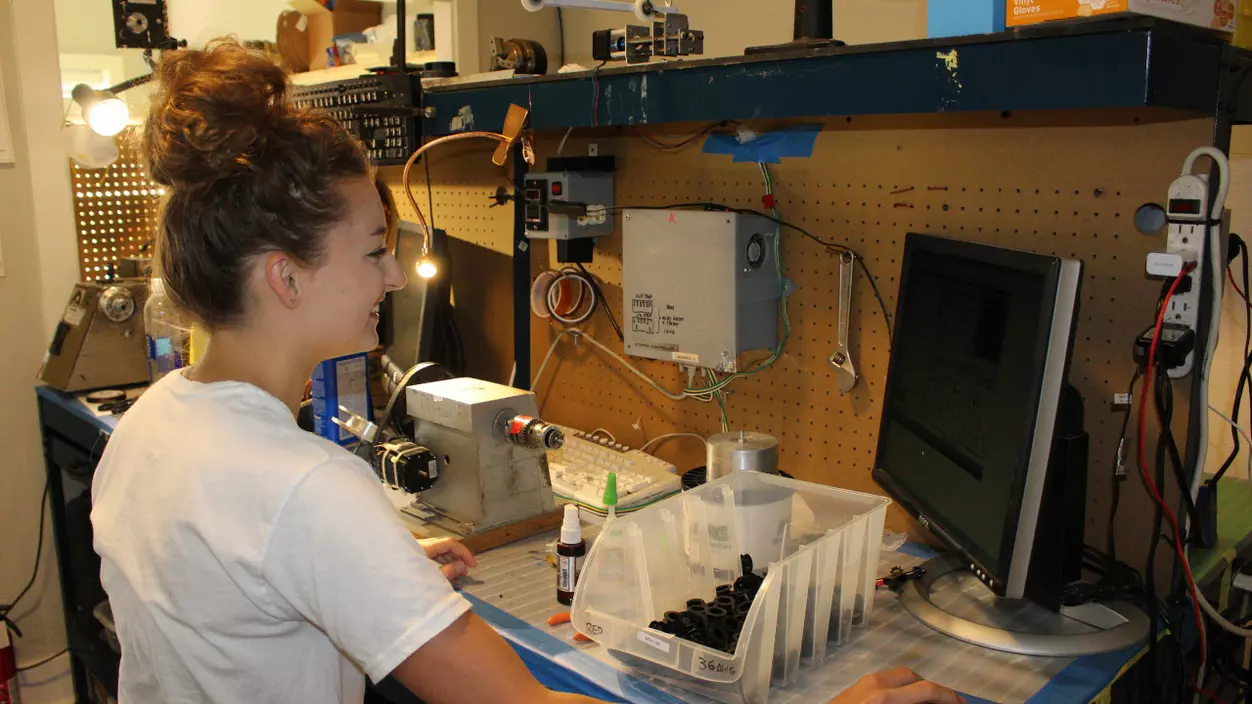 Emma McAllister standing at a workstation